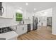 Bright kitchen featuring white cabinets, stainless steel appliances, and an island with a marble countertop at 125 Marilyn Ct, Fayetteville, GA 30214