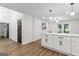Spacious kitchen with white cabinets, stone countertops, and pendant lighting at 125 Marilyn Ct, Fayetteville, GA 30214