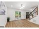 Open living area with wood-look flooring, natural light, and a staircase at 125 Marilyn Ct, Fayetteville, GA 30214