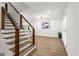 Bright, open-concept living area featuring hardwood floors and a modern staircase with metal railings at 125 Marilyn Ct, Fayetteville, GA 30214
