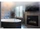 Luxurious bathroom with a modern tub, fireplace, and a mounted television at 4100 Oak Hill Rd, Douglasville, GA 30135