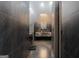 Hallway view of a stylish bathroom with dark tile, marble countertop, and modern lighting at 4100 Oak Hill Rd, Douglasville, GA 30135