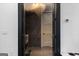 Modern bathroom featuring a stylish chandelier, dark tile, and an open doorway at 4100 Oak Hill Rd, Douglasville, GA 30135