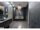Elegant bathroom with marble countertops, tiled floors, a modern chandelier, and sleek cabinets at 4100 Oak Hill Rd, Douglasville, GA 30135