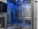 Modern bathroom featuring a walk-in shower with geometric tiles, a TV, and sleek fixtures at 4100 Oak Hill Rd, Douglasville, GA 30135