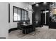 Modern dining room with black marble table, stylish light fixture, and a wall of sleek black cabinetry at 4100 Oak Hill Rd, Douglasville, GA 30135
