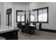 Dining room with black dining table, six chairs, modern light fixture, and large windows with arched design at 4100 Oak Hill Rd, Douglasville, GA 30135