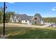 A beautiful custom home with stone and painted brick detail on a large lot and blue skies at 4100 Oak Hill Rd, Douglasville, GA 30135