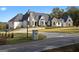 Exterior view of a beautifully landscaped home with a curved driveway at 4100 Oak Hill Rd, Douglasville, GA 30135