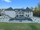 A luxurious home exterior with a pool and waterfall feature in the backyard at 4100 Oak Hill Rd, Douglasville, GA 30135