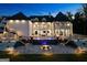 Elegant home exterior featuring a pool, stone terrace, manicured lawn, and sophisticated outdoor lighting at 4100 Oak Hill Rd, Douglasville, GA 30135