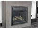 Close-up of a modern fireplace with a gray stone surround, adding warmth and ambiance to the home at 4100 Oak Hill Rd, Douglasville, GA 30135