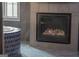 Modern fireplace in a bathroom, surrounded by textured dark tile and a decorative tub at 4100 Oak Hill Rd, Douglasville, GA 30135