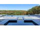 Backyard infinity edge pool features an attached jacuzzi tub, fire pits, and forest views at 4100 Oak Hill Rd, Douglasville, GA 30135
