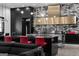 Open kitchen with black cabinets, marble backsplash, stainless steel hood, and red barstools at the island at 4100 Oak Hill Rd, Douglasville, GA 30135