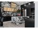 Kitchen featuring marble backsplash, stainless steel hood, black cabinets, countertops and central island at 4100 Oak Hill Rd, Douglasville, GA 30135