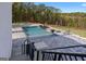 Stunning pool area with patio, landscaped surroundings, fire bowls, and open view; perfect for outdoor relaxation at 4100 Oak Hill Rd, Douglasville, GA 30135