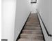 Staircase with wood treads, black handrail and integrated lighting, offering a sleek design at 4100 Oak Hill Rd, Douglasville, GA 30135