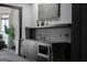 Wet bar features dark wood cabinetry, granite countertops and stainless steel microwave at 4100 Oak Hill Rd, Douglasville, GA 30135