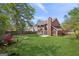 Large, green backyard with a patio seating area, bordered by a wood fence at 848 Gateshead Ct, Lawrenceville, GA 30043