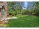 Lush green backyard featuring a patio set and well-maintained lawn with mature trees and landscaping at 848 Gateshead Ct, Lawrenceville, GA 30043