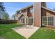 Spacious, well-manicured backyard with a concrete patio and brown wood paneled house at 848 Gateshead Ct, Lawrenceville, GA 30043