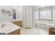 Bright bathroom with double sink vanity, separate tub and shower, and neutral tiling at 848 Gateshead Ct, Lawrenceville, GA 30043
