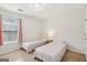 Bright bedroom with two twin beds, neutral carpet, window, and pink curtains at 848 Gateshead Ct, Lawrenceville, GA 30043