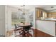 Cozy dining area featuring a wooden table and chairs, tile floor, and a view of the backyard at 848 Gateshead Ct, Lawrenceville, GA 30043