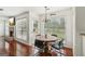 Dining room with views of the backyard, chandelier, and wood floors flows seamlessly into the living room at 848 Gateshead Ct, Lawrenceville, GA 30043