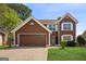 Charming two-story home featuring a two-car garage and a well-manicured lawn at 848 Gateshead Ct, Lawrenceville, GA 30043