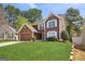 Traditional two-story home with well-maintained lawn and mature trees in a suburban setting at 848 Gateshead Ct, Lawrenceville, GA 30043