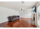 Bright living room features hardwood floors, brick fireplace, ceiling fan, and a comfortable sofa at 848 Gateshead Ct, Lawrenceville, GA 30043