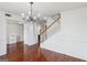Open living area with hardwood floors, staircase, and chandelier lighting at 848 Gateshead Ct, Lawrenceville, GA 30043