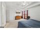 Bright main bedroom with natural light, neutral carpet, tray ceiling, and view of the outdoors at 848 Gateshead Ct, Lawrenceville, GA 30043