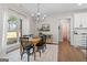 Bright dining room features a wooden table with seating for four and modern decor at 1017 Riverstone Dr, Social Circle, GA 30025