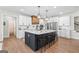 Elegant kitchen with a large island, pendant lighting, and modern appliances at 1017 Riverstone Dr, Social Circle, GA 30025