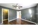 Bedroom with gray walls, hardwood floors, ceiling fan, and closet at 1068 Little Vine Church Rd, Villa Rica, GA 30180