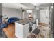 Kitchen island with granite countertops, white cabinets, and open layout to living areas at 40 Circle Dr, Hampton, GA 30228