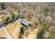 Stunning aerial view of home with a long driveway, surrounded by mature trees on a spacious lot at 6365 Mountain View Trl, Cumming, GA 30041