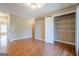 A spacious bedroom with wood floors, neutral walls, and a closet at 6365 Mountain View Trl, Cumming, GA 30041
