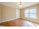 Cozy bedroom featuring hardwood floors, natural lighting, and classic trim and baseboards at 6365 Mountain View Trl, Cumming, GA 30041