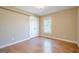 An empty bedroom with wood floors and a window at 6365 Mountain View Trl, Cumming, GA 30041