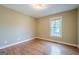 An empty bedroom with wood floors and a window at 6365 Mountain View Trl, Cumming, GA 30041