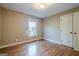 An empty bedroom with wood floors and a window at 6365 Mountain View Trl, Cumming, GA 30041