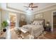 A beautifully staged bedroom with wood floors, neutral walls, and a bathroom ensuite entrance at 6365 Mountain View Trl, Cumming, GA 30041