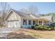 Attractive home with a two-car garage, covered porch and mature landscaping at 6365 Mountain View Trl, Cumming, GA 30041