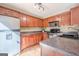 Well-lit kitchen featuring wood cabinets, stainless steel appliances, and laminate countertops at 6365 Mountain View Trl, Cumming, GA 30041