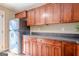 Kitchen featuring wood cabinets, stainless steel refrigerator, laminate countertop, and hardwood flooring at 6365 Mountain View Trl, Cumming, GA 30041