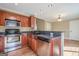 Kitchen area with a microwave, dishwasher, and stainless steel appliances with wood cabinets at 6365 Mountain View Trl, Cumming, GA 30041